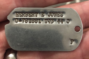 Photo of Captain Herbert E Jones’s Original Military issued 1943 US Army Dog Tag Photo of Captain Herbert E Jones’s Original Military issued 1943 US Army Dog Tag