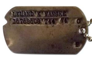 Photo of original military 1943 US Army Air Corps Dog Tags issued to Corporal Leland Kendall Manske