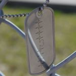 Heartbeat Dog Tag on chain link fence