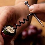 Mini Corkscrew twisting into cork on wine bottle